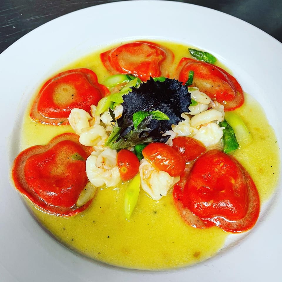Buona Sera Ristorante's red ravioli in a yellow sauce with shrimp, asparagus, and cherry tomatoes.