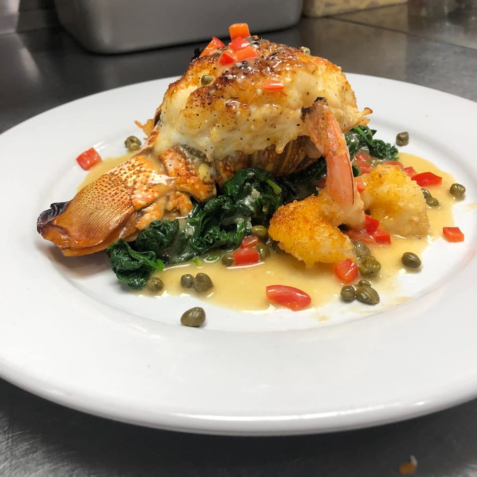 Buona Sera Ristorante's lobster tail and shrimp dish with spinach, tomatoes, and capers.